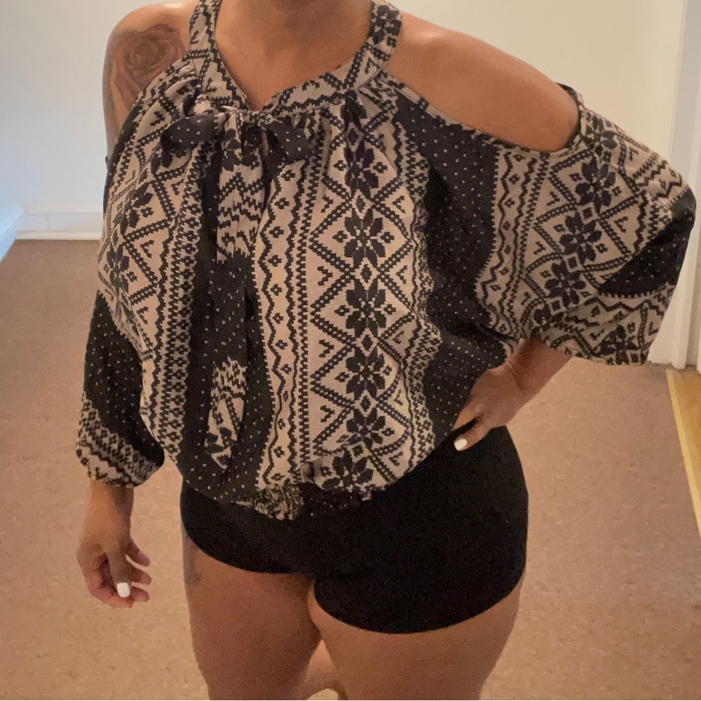 Black and Tan design shirt with shoulders exposed and straps to tie at neck.